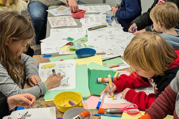 Children performing artwork during a classroom activity