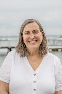 Sara Lomasz Flesch stands in front of Lake Mendota